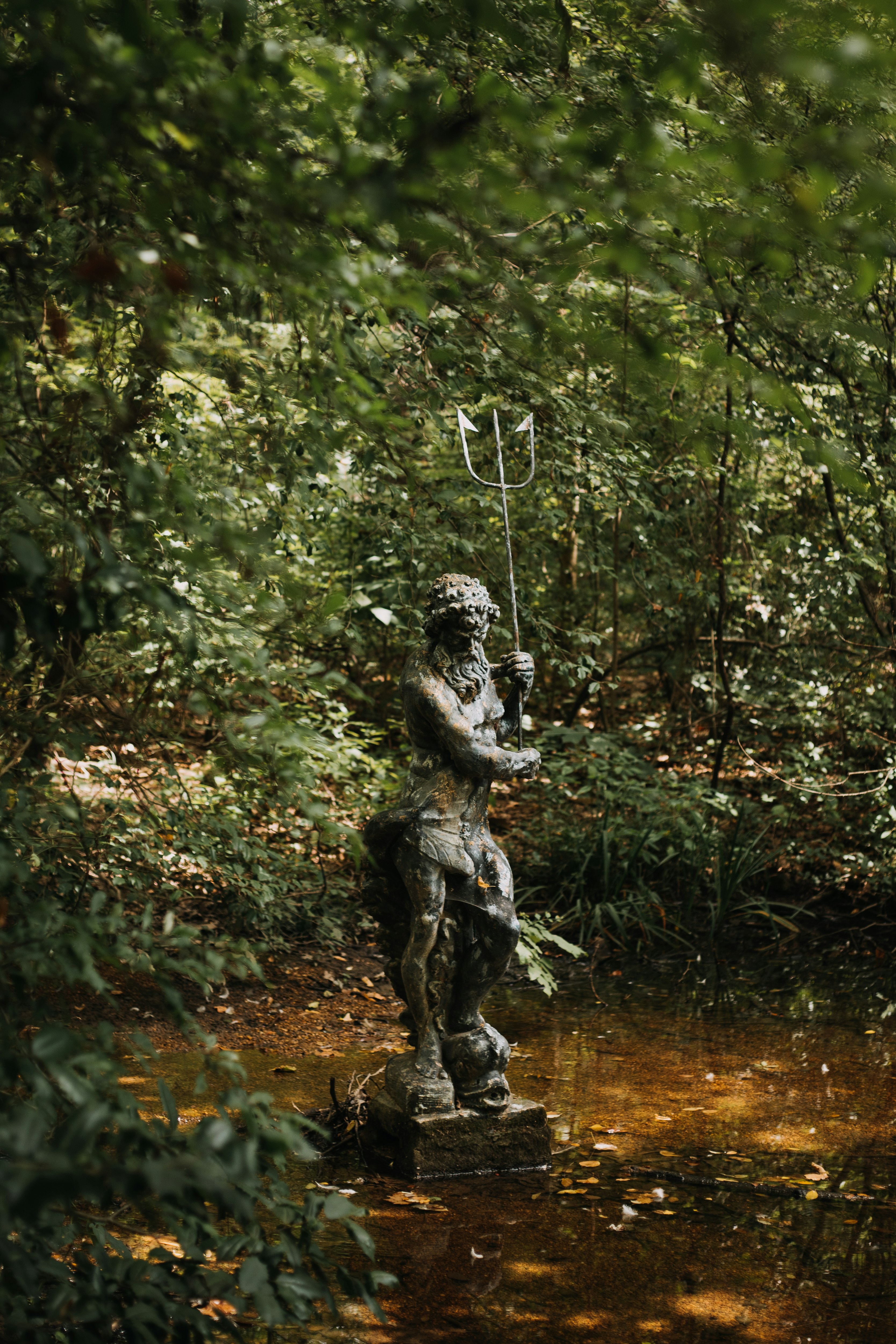 woman statue in the middle of the forest